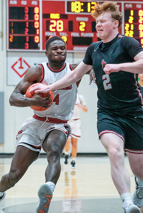 Yannis Nlend battles through contact at the rim during the Trappers&rsquo; matchup against North Idaho on Saturday. Northwest suffered its first home defeat of the season to the Cardinals.