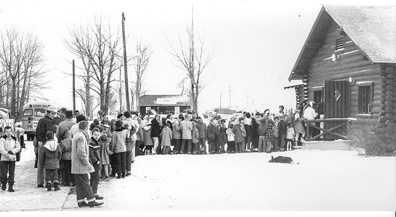 People line up to enter a community gathering in a photo from the Powell Tribune 50s and 60s collection at the Homesteader Museum. The museum is bringing back Sunday community gatherings.&nbsp;