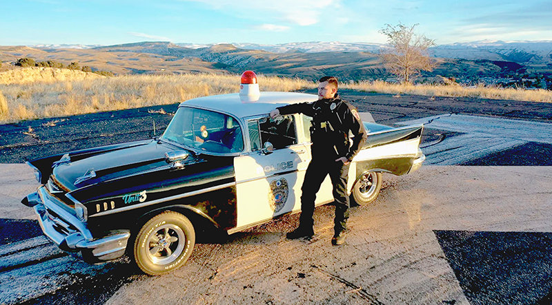 Thermopolis police officer Dood Jaussaud shows off his 1957 Chevrolet Bel Air police car during the production of a short film at the old airport air strip. Jaussaud bought and restored the car.