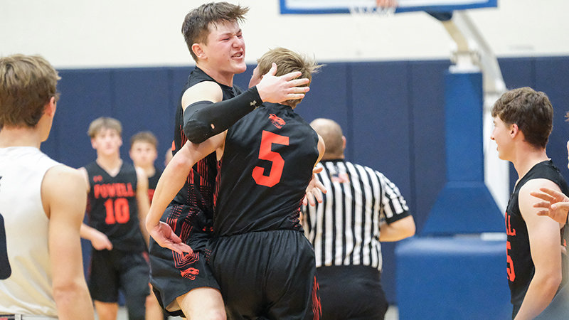 Jhett Schwahn (left) rushes to celebrate with Evan Whitlock after his late free throws helped the Panthers defeat the Cody Broncs in Cody on Friday.