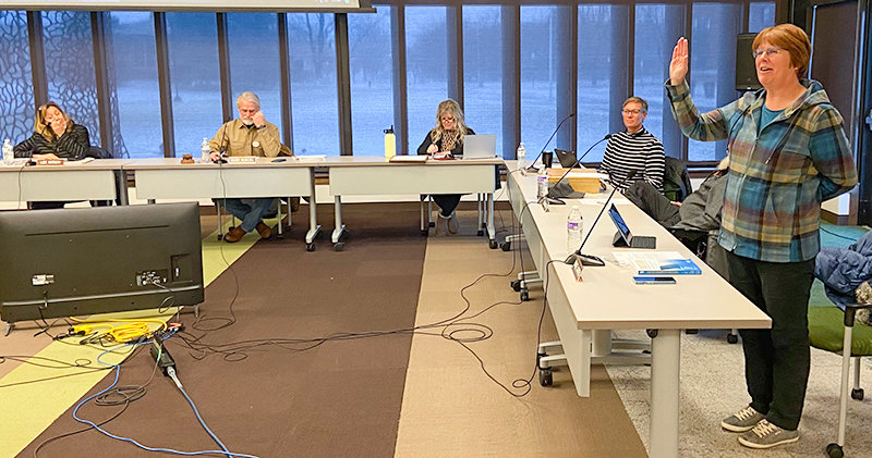 Denise Laursen (far right) gives her oath of office as she starts her first meeting on the Northwest College Board of Trustees on Dec. 12 as fellow board members and staff look on.