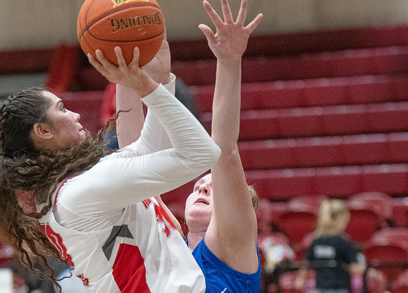 Darla Hernandez puts up a mid-range shot over a Miles Community College defender during the Trappers final home game before break on Dec. 16.