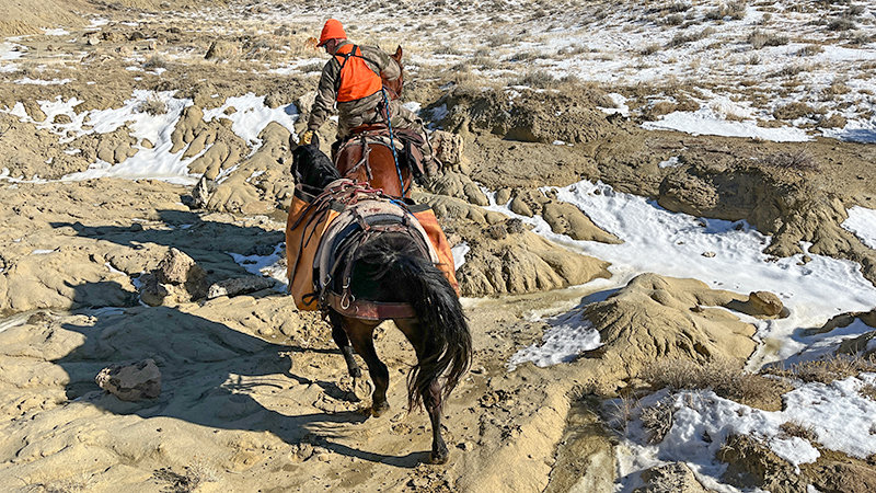 Frank Fagan negotiates rough terrain on his horse, Buddy, while moving through public land near Heart Mountain during a cold day in the 2022 elk season. The experienced hunter and horseman volunteered to assist the Tribune&rsquo;s clumsy outdoors reporter on local hunts in Park County.