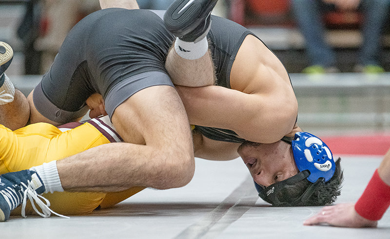Bobur Berdiyorov holds down his opponent during a dual with Montana State University-Northern on Tuesday. Berdiyorov is the top-ranked wrestler at 141 pounds in NJCAA.