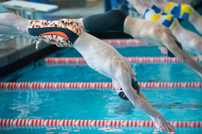 Cole Fauskee launches into the water to start the 50 free during the Worland Invitational on Saturday.