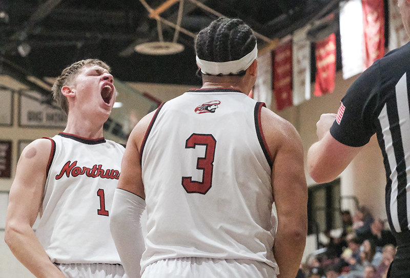 Will Hemme celebrates with Davion McAdam after a basket plus the foul during the Trappers victory on Saturday.