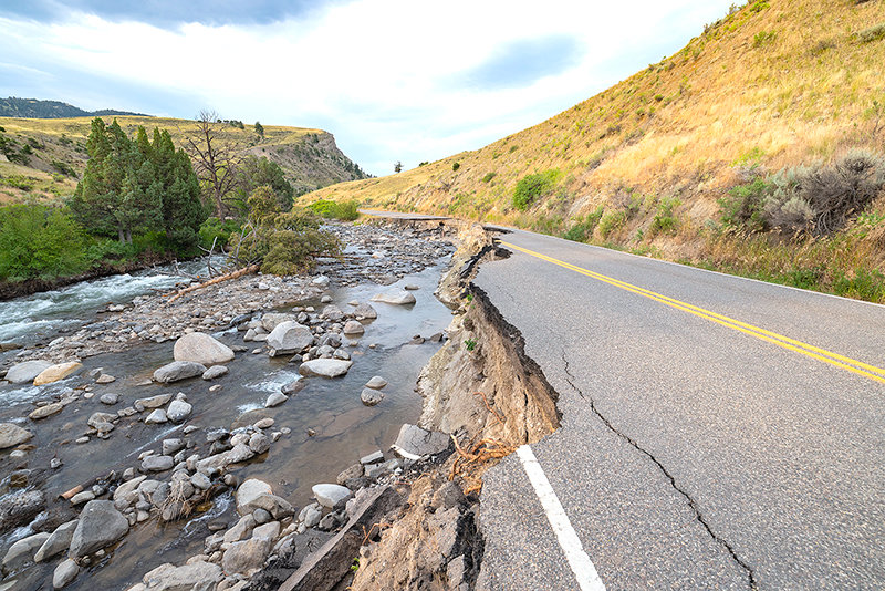 The Northeast Entrance road between Gardiner, Montana, and Mammoth Hot Springs was washed away in the June flood that closed Yellowstone National Park. While other entrances opened within a month, the Northeast and North entrances remained closed into October.