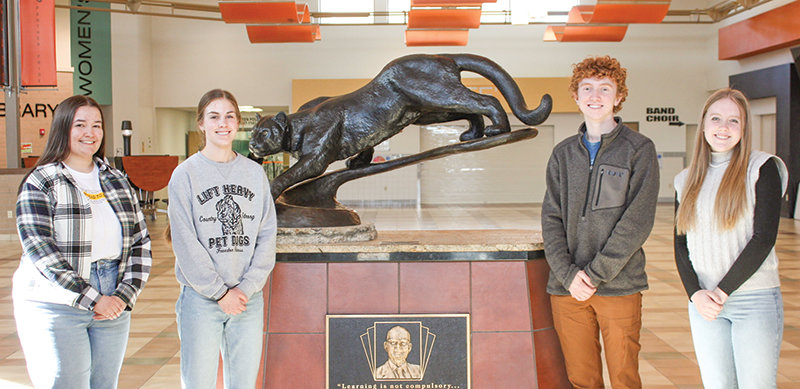 From left, Josie Griffin, Megan Jacobsen, Kalin Hicwsa and Gretel Opps stand in front of the panther statue at Powell High School. All four students received the Trustees&rsquo; Scholars Award to use at the University of Wyoming.