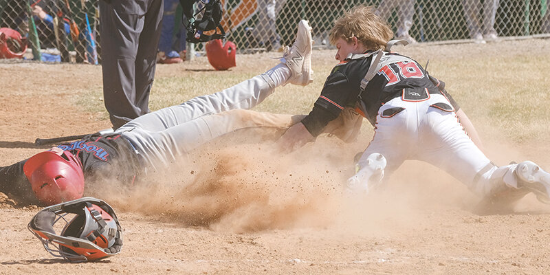 Cole Fauskee dives attempting to tag out a Trooper during the Pioneer&rsquo;s opening games on April 16. The Pioneers return home Sunday for a doubleheader at 11 a.m. and 1 p.m. with Evanston.