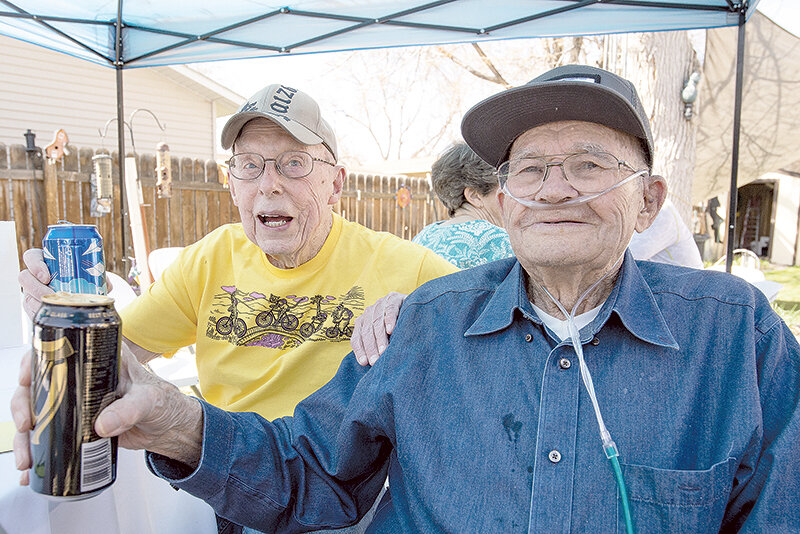 Buzz Larsen (left) and LeRoy Davey toast their birthdays Sunday. The two friends, bonded by their love for bicycling, share May 2 as their birthdays. Larsen is 90 this year and Davey is 94.