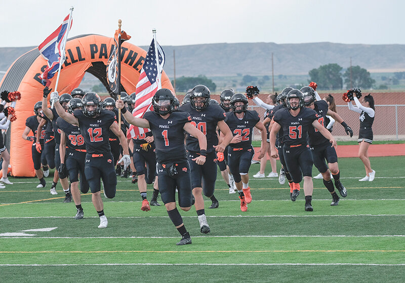 The Powell Panthers run onto the current Panther Stadium turf field before a game last fall.
