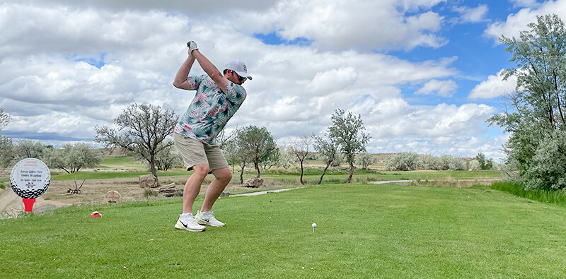 Cody Chamblin of Cody tees off on hole No. 1 during the Trapper Bonanza fundraiser golf tournament at Powell Golf Club Saturday, June 3. Sixteen four-person teams participated in this year&rsquo;s Scramble format event to support Northwest College athletics.