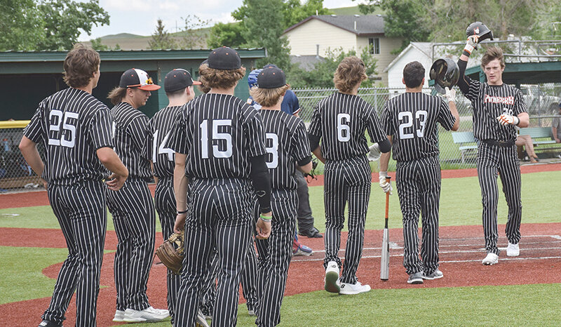 Trey Stenerson (right) is greeted by teammates after hitting a home run against Sheridan on Sunday. Powell will head to Billings this weekend for the BWW Tournament starting Thursday (today).