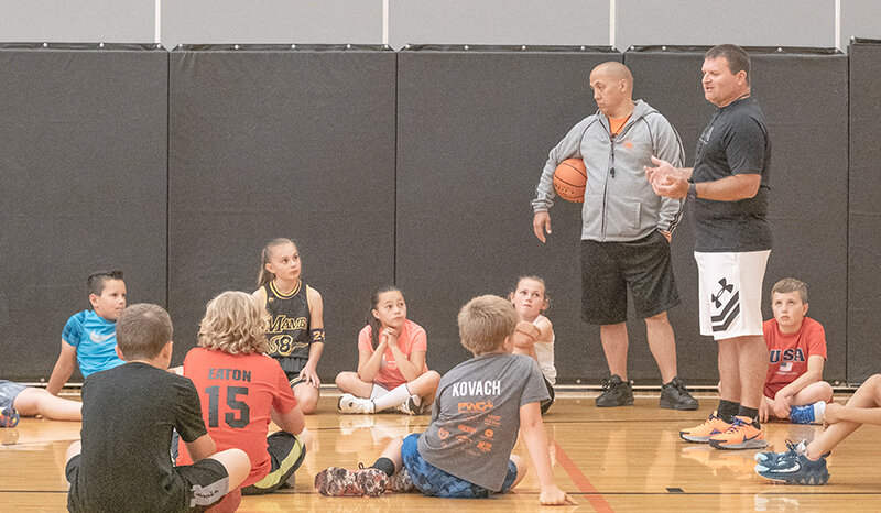 Coaches Waleryan Wisniewski and Mike Heny (right) give instruction to the younger players at the Trapper and Panther boys&rsquo; basketball camp on Tuesday. The camp saw an increase in attendance after a lower attendance rate last year.