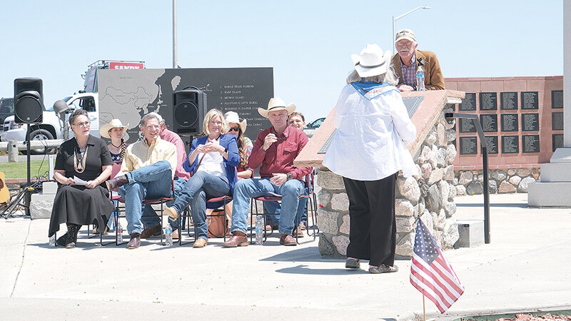 Park County Republican Party Chair Martin Kimmet (from right) recognizes organizer Carol Armstrong for putting together another Freedom Celebration on July 3 at the Wyoming Veterans Memorial Park as Gov. Mark Gordon, Sen. Cynthia Lummis, Sen. John Barrasso and Rep. Harriet Hageman sit with state elected officials and other dignitaries at the start of the event.