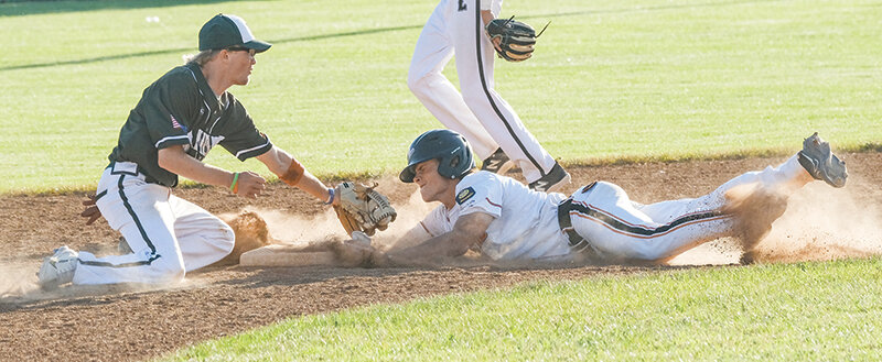 Brock Johnson slides in under a tag attempt as he steals second against Lander on Tuesday.