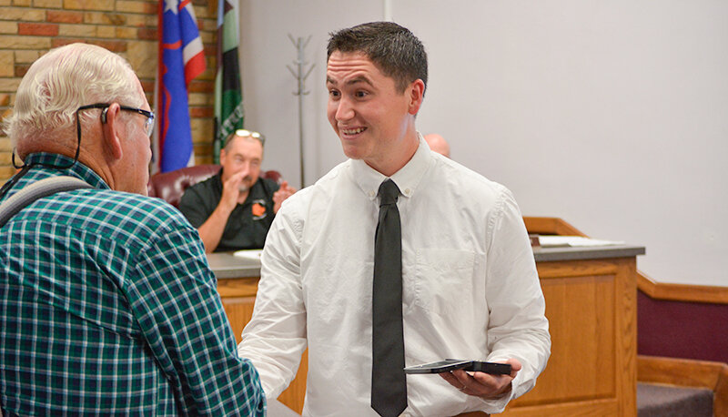 New Powell Police Officer Isaac Gutierrez is congratulated by City Council President Tim Sapp after being sworn in on July 3. Gutierrez is a Powell native and had multiple family members in attendance at the ceremony.
