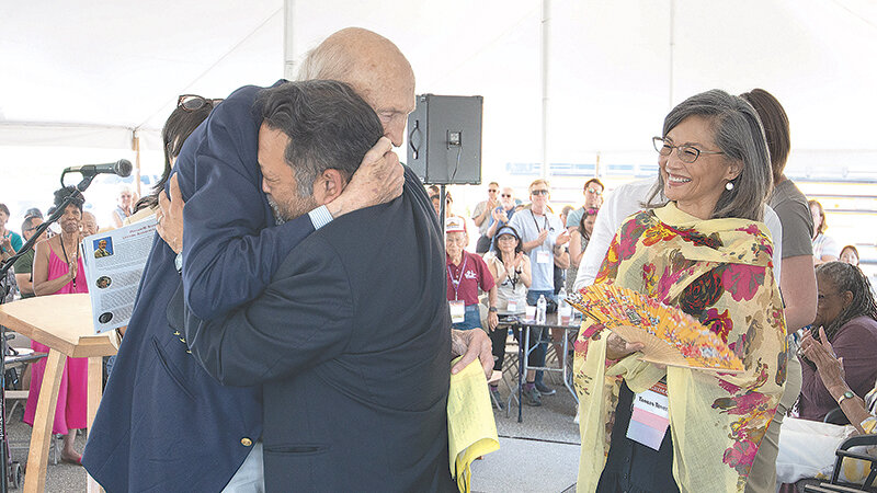 Sen. Al Simpson embraces David Mineta on stage during Saturday&rsquo;s main event during the Heart Mountain Interpretive Center&rsquo;s pilgrimage while actress Tamlyn Tomita watches. Simpson gave the keynote speech at the event.