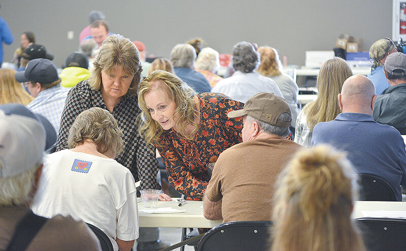 First Deputy Park County Treasurer Anne Lawler (left) and Treasurer Barb Poley (center) assist buyers at Wednesday's tax sale at the Park County Fairgrounds. The county saw an increase in unpaid property taxes and irrigation assessments this year, coinciding with increasing property values and taxes.