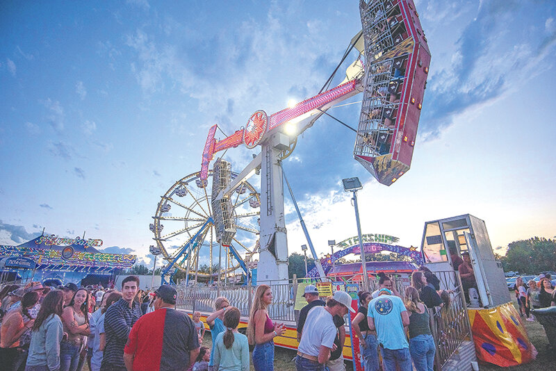 People gather around to watch the carnival rides during the Park County Fair. Attendance was strong for the most part, but staff and board members have concerns with some of the grandstand events.