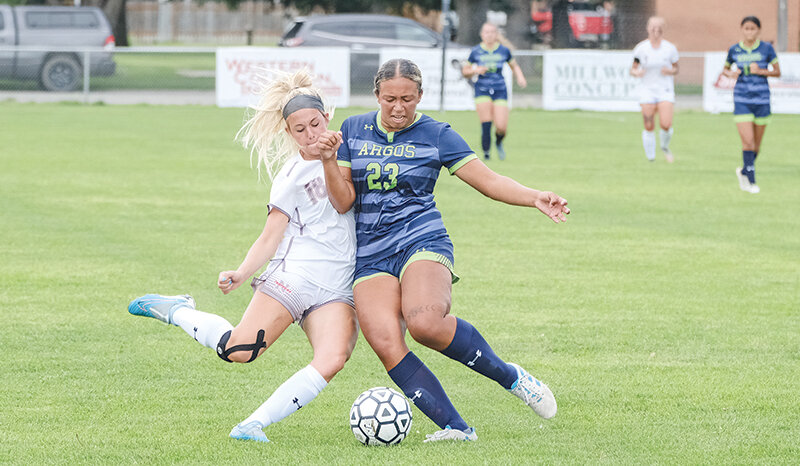 Aspen Kalkowski (left) battles for the ball with a University of Providence defender during a scrimmage last Saturday. Northwest opens the regular season at home today (Thursday) against USU Eastern with games at noon and 2 p.m.