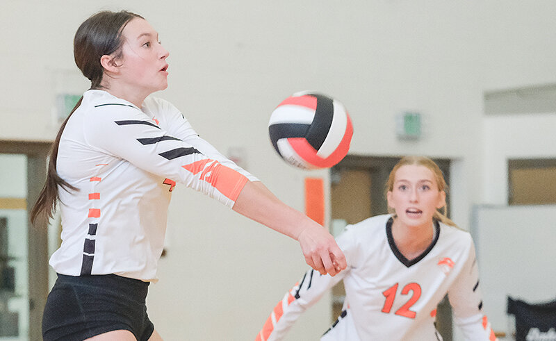 Saige Kidd (left) passes a ball while teammate Addy Thorington watches on during the Panthers&rsquo; match against Thermopolis on Friday. Powell rolled in its opening conference matches with a pair of sweeps over Thermopolis and Worland.