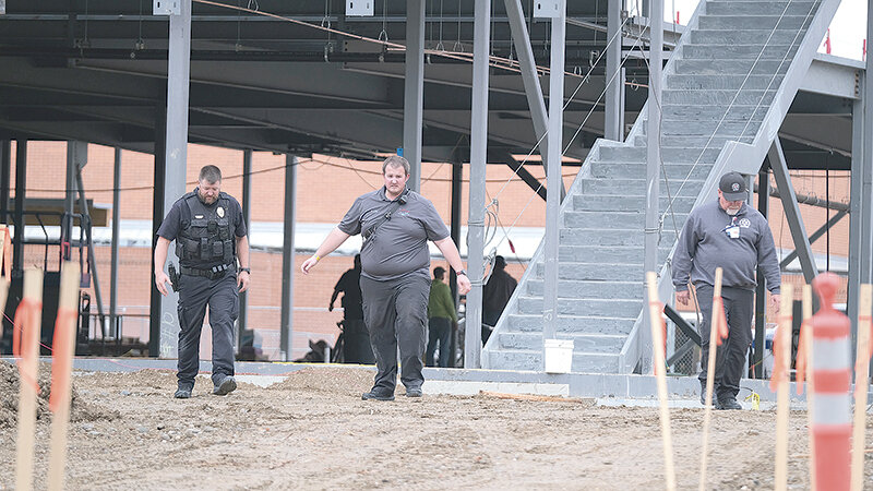 From left, Powell Police Officer Matt Koritnik, Community Service Officer Steven Long and Powell Valley Healthcare Emergency Services Manager Scott Bagnell work the scene of a Tuesday morning accident at the Northwest College student center construction site. A Groathouse construction worker was life flighted to Billings after injuring himself.