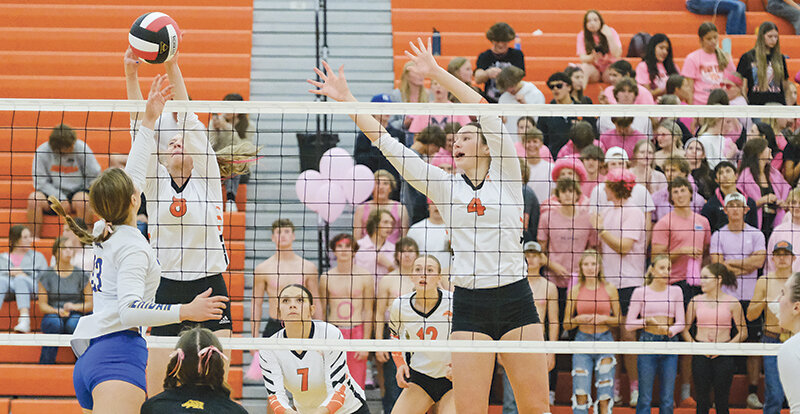 Kodee Asay (left) gets her hand on a ball while Saige Kidd stretches to help. Powell finished with a 3-1 victory over Sheridan Tuesday night in front of a pink-out crowd.