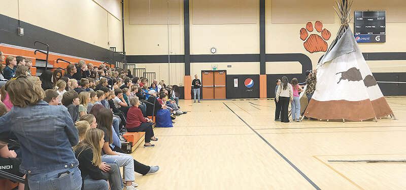 Powell Middle School&rsquo;s sixth grade class watches a tipi demonstration. The demonstration, carried out with the help of the Buffalo Bill Center of the West, concluded a unit on the Crow Indians.
