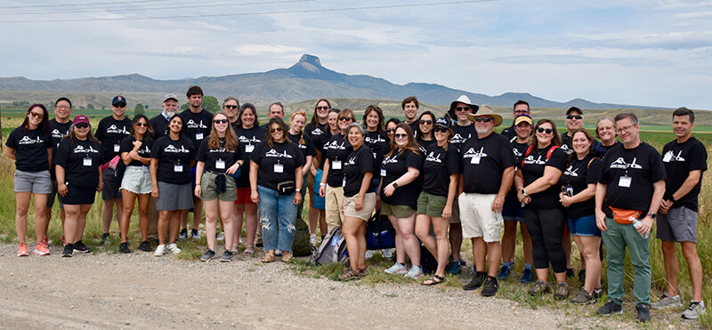 Participants in a 2023 National Endowment for the Humanities Landmarks of American History and Culture workshop stand in front of Heart Mountain.