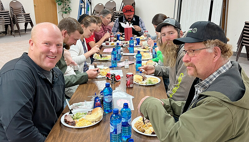 Above left: Fire Chief Mike Aagard, Assistant Fire Chief Brent Yorgason, Marcus Shultz, Jesse Dewey and other volunteers enjoy a meal courtesy of the community.