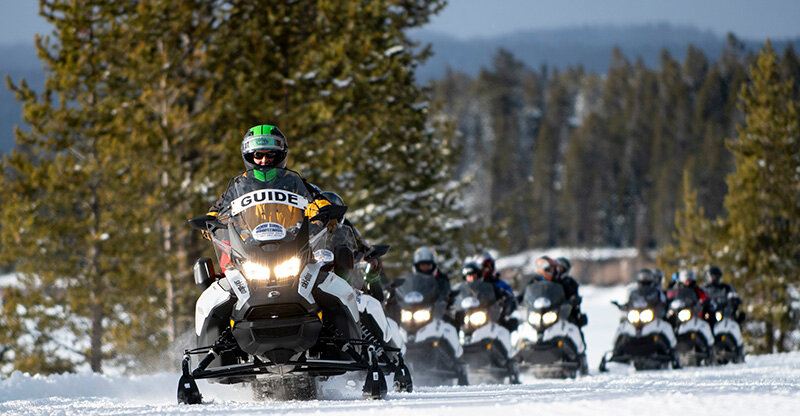Dean Lavoy, oversnow guide for Gary Fales Outfitters, leads a group of 17 tourists on snowmobiles through Yellowstone National Park during a recent winter season. Outdoor recreation spending increased $2 billion in Wyoming from 2021 to 2022.