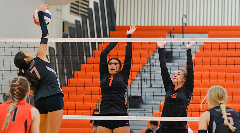 Melanie Garcia (center) and Sharae Shoopman (right) rise up to block a ball for the Panther JV team. The team learned throughout the season, finishing 6-19.