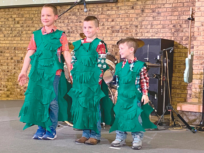 A trio of trees stand tall during the Powell Christian School concert on Dec. 3. From left, Dominic Shrive, Lincoln Wiggins and Evertt Wiggins.