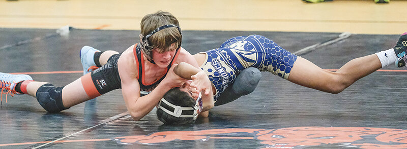 Tucker McDonald holds down a Cody wrestler during a dual in late November. The Cubs finished as conference champions for the first time in four years.