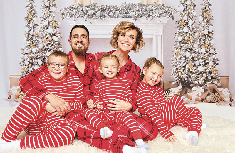 Katelyn Showalter (right) poses with her family for a Christmas photo. Showalter is pursuing treatment for failure to thrive, a condition normally found in infants, along with other medical conditions. Back row, from left: Tyler Showalter with his wife Katelyn. Front row, from left: Liam Showalter, Kalvyn Showalter and Chloee Showalter.