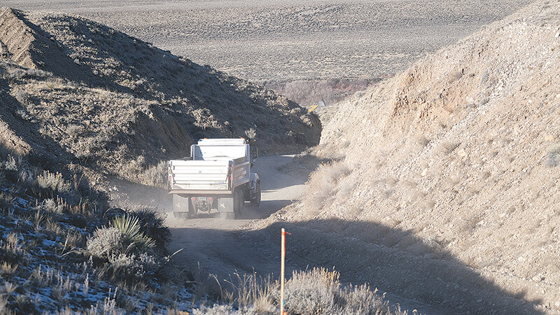 A dump truck progresses down County Road 7RP in Clark in late November early in the project to widen a section of the road to increase safety and visibility, while building up the road base on another section.