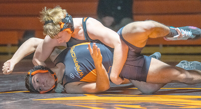 Jeremy Harms (top) turns Lucas Ramirez on his way to a pin during a dual with Worland on Thursday. Powell ran away with the victory 66-12 before heading to Lander for a third place finish Friday and Saturday.