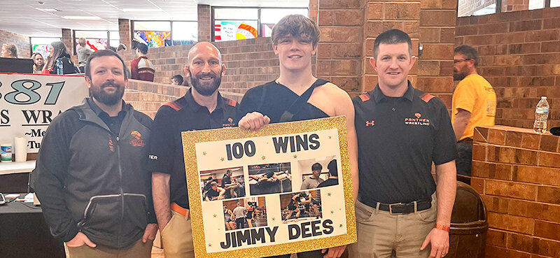 Jimmy Dees (second from right) celebrated his 100th win in Riverton at the Ron Thom Memorial. He is joined by coaches (from left) Cody Kalberer, Juston Carter and Nick Fulton.