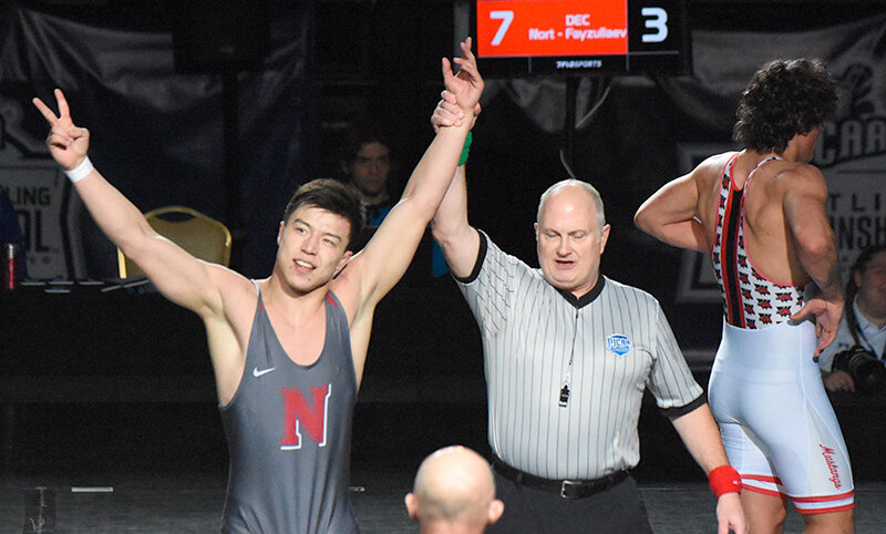 Aziz Fayzullaev raises two fingers, one for each of his national titles at 174 and 184 pounds. He won the title bout against Western Wyoming&rsquo;s Darion Johnson last Saturday at the NJCAA National Wrestling Championships in Council Bluffs, Iowa.