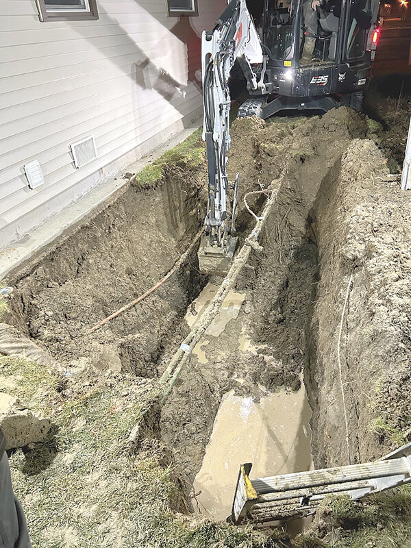 City of Powell personnel work to excavate a broken water main alongside Don and Diane Branstetter&rsquo;s Avenue G home on Dec. 3. Water from the city&rsquo;s leaking pipe flooded the Branstetters&rsquo; crawl space and ruined their water heater.