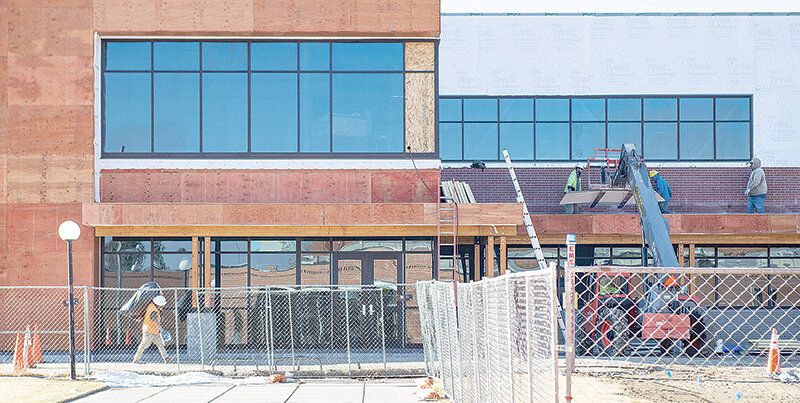 Construction crews take advantage of the nice weather to work on the exterior of the new student center on the Northwest College campus. The facility is scheduled to open this coming fall.