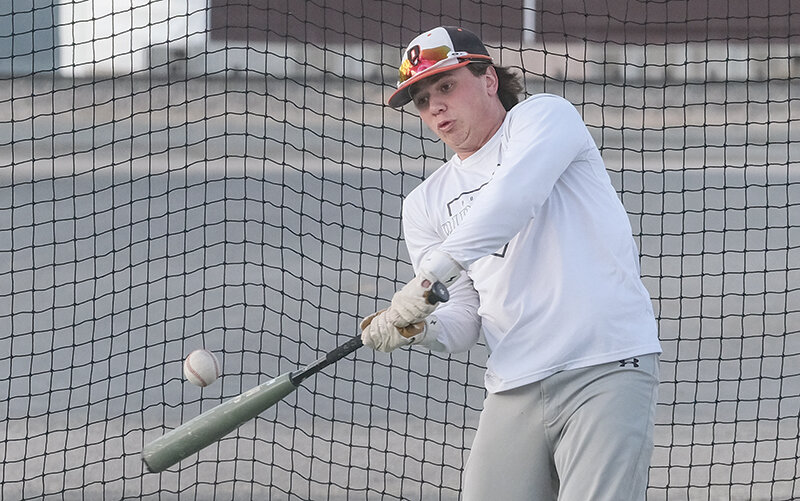Aiden Greenwald swings through a ball during batting practice. He is one of a number of returning Pioneers this season looking to defend a state title.