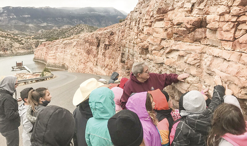 Greg Jones, a volunteer with the Bighorn Canyon National Recreation Area, talks with a group of students about a rock formation. Bighorn Canyon is celebrating National Parks Week with a number of events next week.