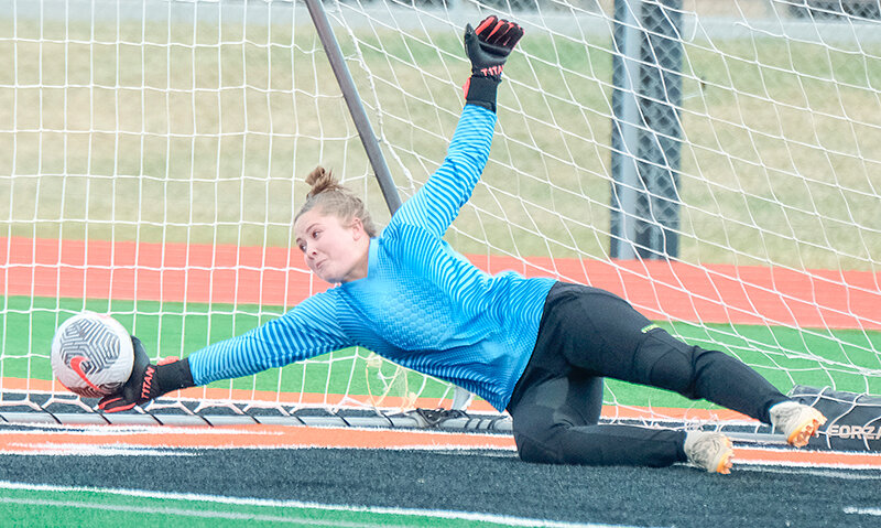 Josie Hallock dives to get her hand on the final penalty during the shootout against Lander on Friday. Powell defeated Lander 5-4 in the shootout after Hallock saved the second shot from the Tigers after a 2-2 regulation scoreline.
