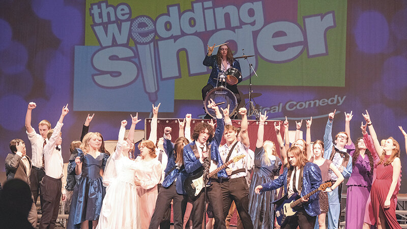 The Powell High School drama club poses after completing the first dance number of ‘The Wedding Singer: The Musical Comedy’ during practice on Tuesday. The play can be seen in its entirety Friday and Saturday at 7 p.m.