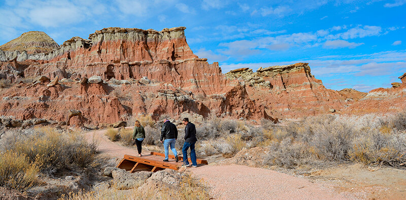People walk over a new foot bridge built as part of the Gooseberry Badlands project on a trail west of Worland.