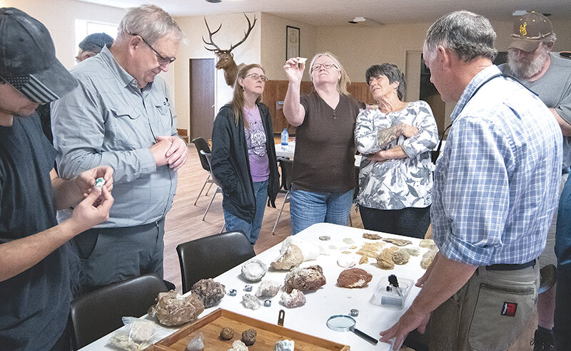 Joey Andrade, Greg Jones, Lara Meyers, Cindy Cordova, Denise Holbert, Ned Kelley and (in corner) Ron Beebe check out many mineral specimans found in Wyoming during the Shoshone Rock Club May meeting. The club, along with the Cody 59ers Rock Club and the Wyoming State Mineral and Gem Society are sponsoring the state&rsquo;s largest rock show May 30 to June 1 at the Park County Fairgrounds.