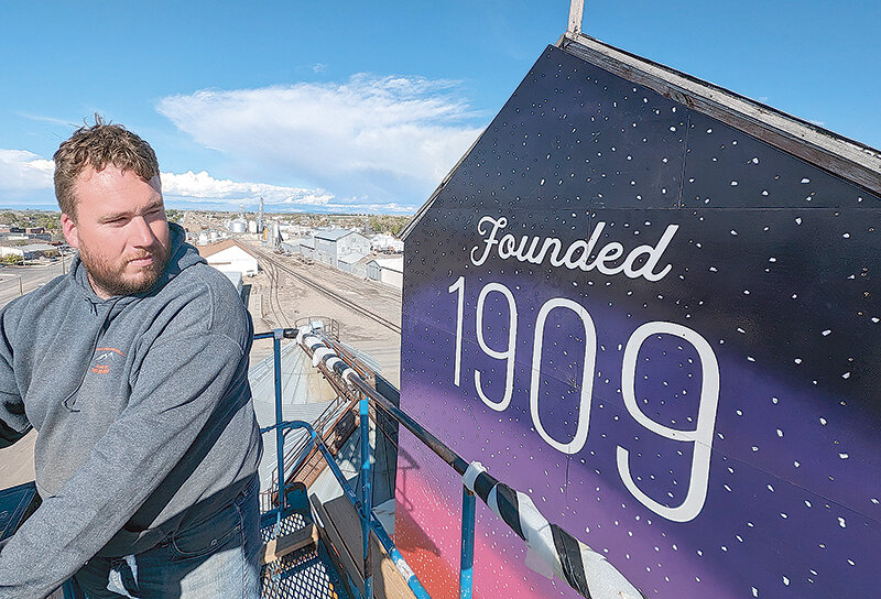 LM Construction Manager Ethan Joy looks out over a freshly installed mural atop a Treasure Valley Seed elevator Tuesday evening. Roughly a year in the making, the mural revamp came together with the help of several companies, governmental entities and organizations.