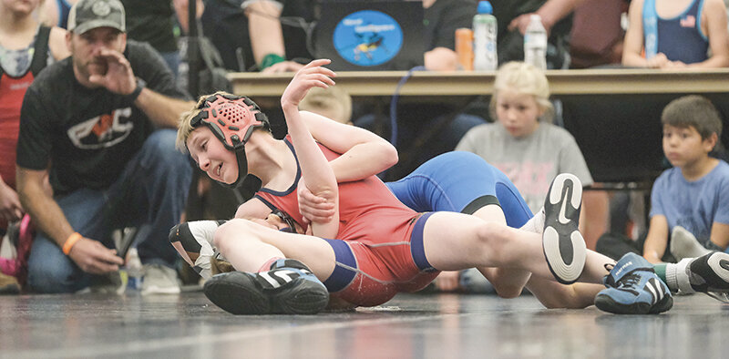 Paele Rapp holds down his opponent during the Powell Wrestling Tournament in April. Powell saw competitors from around Wyoming and Montana flock to the annual home tournament.